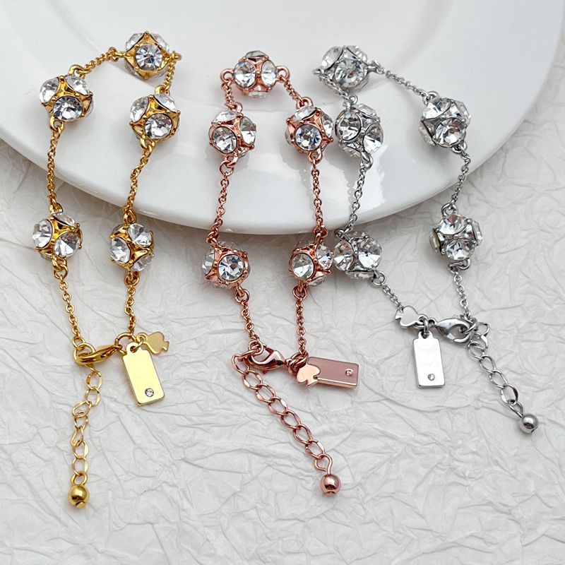  Bracelet on a soft cream or warm terracotta background, emphasizing the warm glow of the orange crystals. Alt: “Kate Spade Lady Marmalade Station Bracelet – Citrine Crystal Jewelry.”