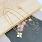  Mini spade pendant necklace on a soft pink or neutral backdrop, highlighting its delicate scale and engraved details. Alt: “Kate Spade Legacy Spade Flower Mini Pendant Necklace – Dainty Logo Jewelry.”