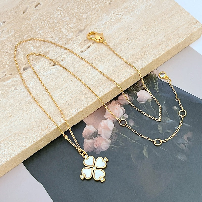  Mini spade pendant necklace on a soft pink or neutral backdrop, highlighting its delicate scale and engraved details. Alt: “Kate Spade Legacy Spade Flower Mini Pendant Necklace – Dainty Logo Jewelry.”