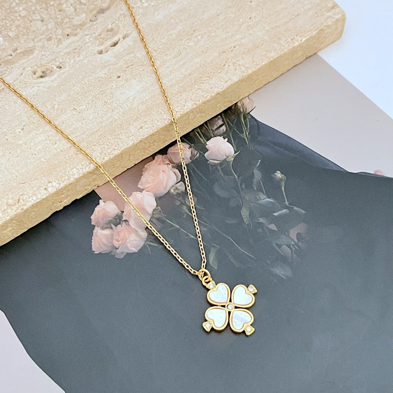  Mini spade pendant necklace on a soft pink or neutral backdrop, highlighting its delicate scale and engraved details. Alt: “Kate Spade Legacy Spade Flower Mini Pendant Necklace – Dainty Logo Jewelry.”