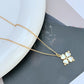 Mini spade pendant necklace on a soft pink or neutral backdrop, highlighting its delicate scale and engraved details. Alt: “Kate Spade Legacy Spade Flower Mini Pendant Necklace – Dainty Logo Jewelry.”
