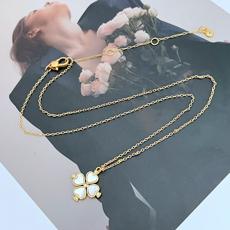  Mini spade pendant necklace on a soft pink or neutral backdrop, highlighting its delicate scale and engraved details. Alt: “Kate Spade Legacy Spade Flower Mini Pendant Necklace – Dainty Logo Jewelry.”