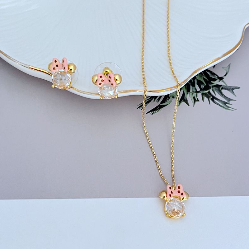 Necklace displayed on a clean, light background (white or pale pink), showing the Minnie slider charm positioned mid-chain. Alt: “Kate Spade New York Minnie Slider Necklace – Disney-Inspired Gold Charm Jewelry.”