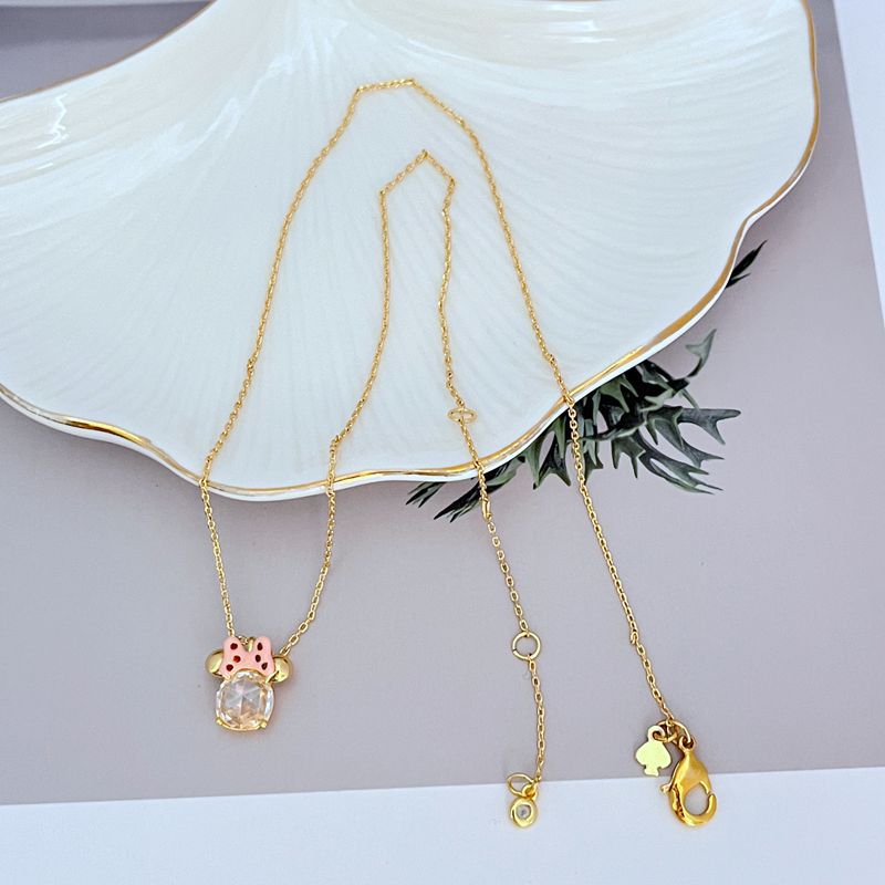 Necklace displayed on a clean, light background (white or pale pink), showing the Minnie slider charm positioned mid-chain. Alt: “Kate Spade New York Minnie Slider Necklace – Disney-Inspired Gold Charm Jewelry.”