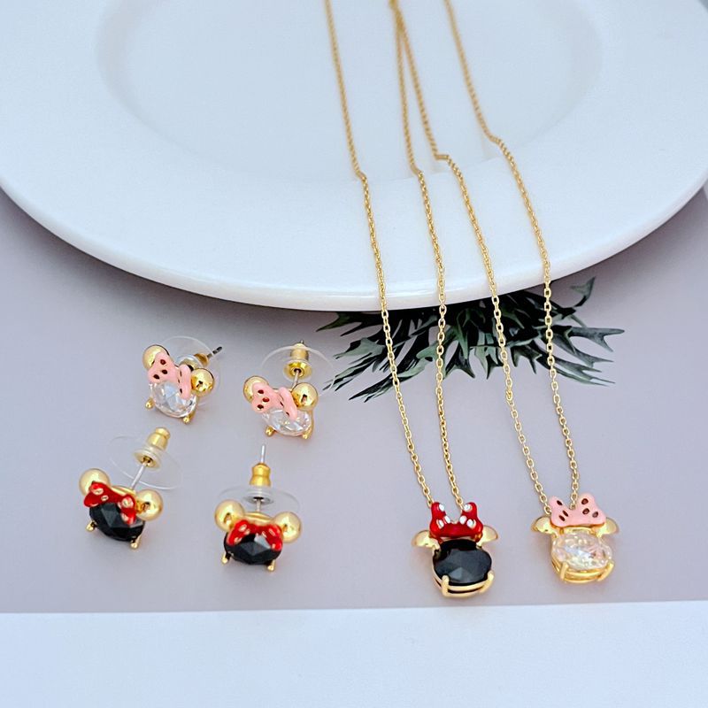 Necklace displayed on a clean, light background (white or pale pink), showing the Minnie slider charm positioned mid-chain. Alt: “Kate Spade New York Minnie Slider Necklace – Disney-Inspired Gold Charm Jewelry.”