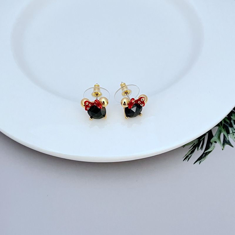 Macro focus on the Minnie charm, highlighting the bow shape, facial details, and slider mechanism. Alt: “Detailed Minnie Mouse Slider Charm – Kate Spade Disney Collection.”