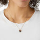  Necklace photographed alongside subtle Disney elements (like polka dots, a vintage Minnie figurine, or a classic red bow) for thematic appeal. Alt: “A Nod to Nostalgia: Styling the Kate Spade Minnie Slider Necklace.”