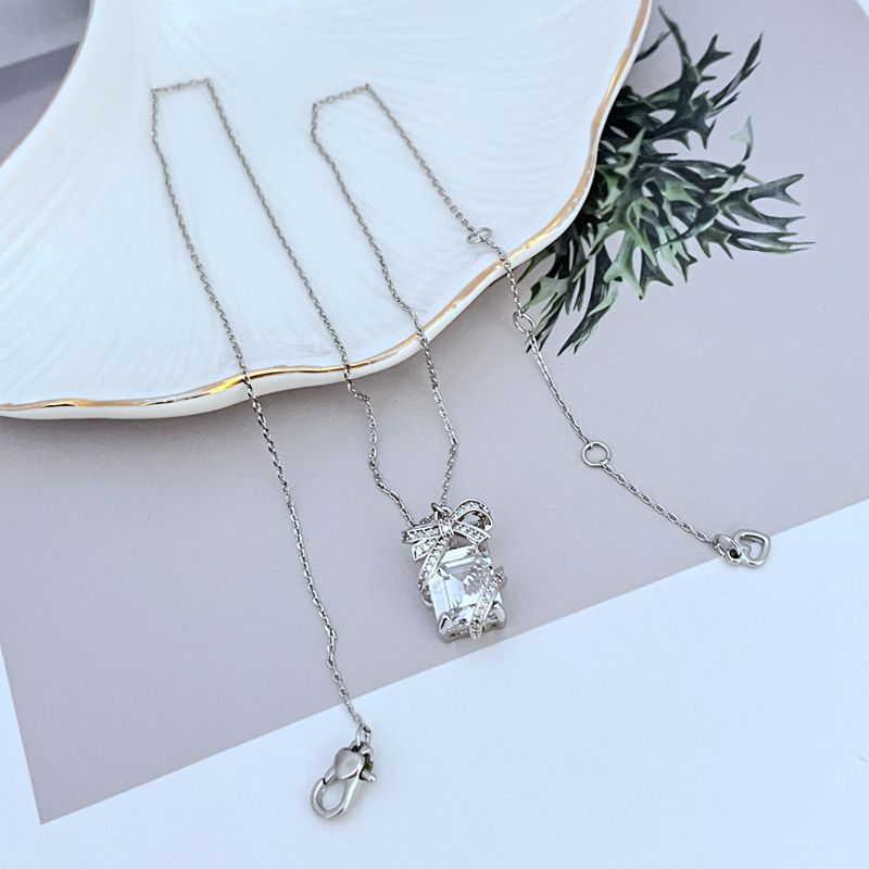 Necklace on a clean, light background, showcasing the crystal-covered present pendant in sharp detail. Alt: “Kate Spade New York Pave Present Pendant Necklace – Sparkling Gift Box Jewelry.”