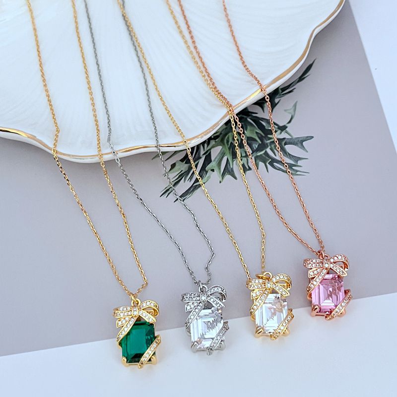 Necklace on a clean, light background, showcasing the crystal-covered present pendant in sharp detail. Alt: “Kate Spade New York Pave Present Pendant Necklace – Sparkling Gift Box Jewelry.”