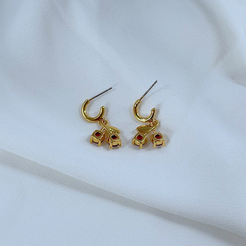  Earrings on a soft pink or cream background, showcasing the red cherries and pastel flowers. Alt: “Kate Spade Red Cherry & Flower Earrings – Enamel Fruit Floral Jewelry.”