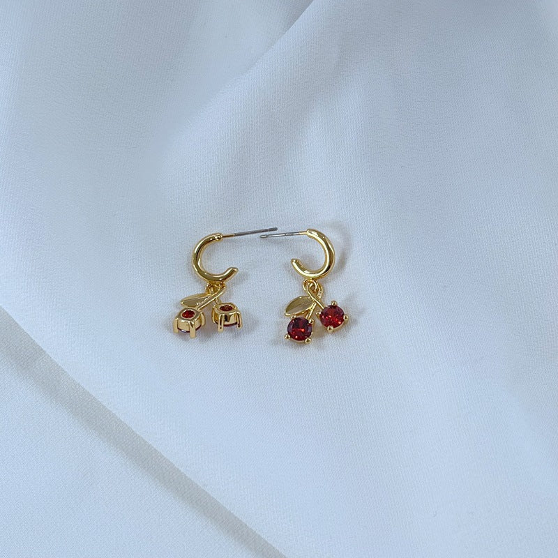  Earrings on a soft pink or cream background, showcasing the red cherries and pastel flowers. Alt: “Kate Spade Red Cherry & Flower Earrings – Enamel Fruit Floral Jewelry.”