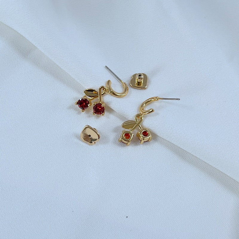  Earrings on a soft pink or cream background, showcasing the red cherries and pastel flowers. Alt: “Kate Spade Red Cherry & Flower Earrings – Enamel Fruit Floral Jewelry.”