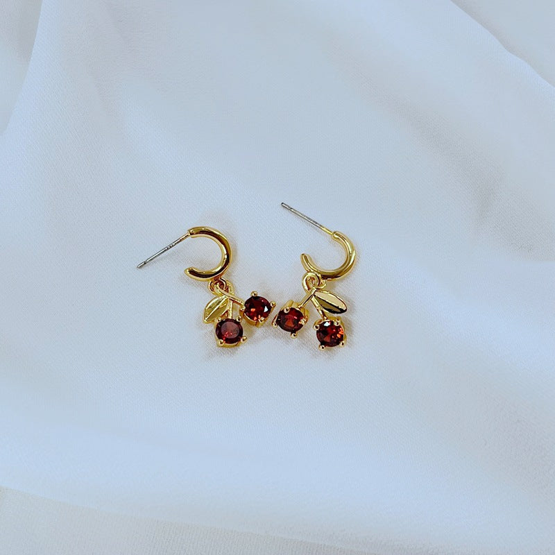  Earrings on a soft pink or cream background, showcasing the red cherries and pastel flowers. Alt: “Kate Spade Red Cherry & Flower Earrings – Enamel Fruit Floral Jewelry.”