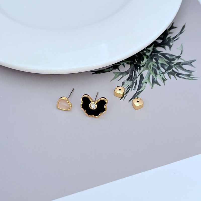 Earrings on soft seafoam or blush background. Alt: “Kate Spade Shell Love Heart Spade Flower Earrings – Enamel Charm Jewelry.”
