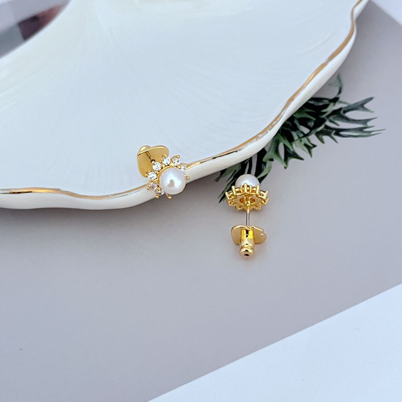 Necklace on a soft, bright background (light blue or creamy white), highlighting the sun pendant's pearl center and crystal halo. Alt: “Kate Spade Sunny Pave & Imitation Pearl Halo Necklace – Radiant Sun Motif Jewelry.”