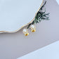 Necklace on a soft, bright background (light blue or creamy white), highlighting the sun pendant's pearl center and crystal halo. Alt: “Kate Spade Sunny Pave & Imitation Pearl Halo Necklace – Radiant Sun Motif Jewelry.”