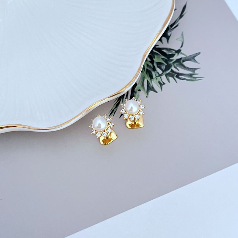 Necklace on a soft, bright background (light blue or creamy white), highlighting the sun pendant's pearl center and crystal halo. Alt: “Kate Spade Sunny Pave & Imitation Pearl Halo Necklace – Radiant Sun Motif Jewelry.”