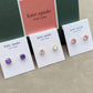 Kate Spade earrings on display with branded cards