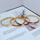 Bracelet on a clean white or light grey background, highlighting the pearl and crystal details. Alt: “Kate Spade New York White Bracelet – Pearl and Crystal Statement Jewelry.”