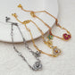 Bracelet displayed on a soft moss green or linen background, highlighting the mix of floral and leaf charms. Alt: “Kate Spade Yellow Gold Plated Flowers & Plants Bracelet – Botanical Charm Jewelry.”