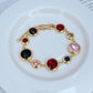 Bracelet on a clean white or soft pastel background, highlighting the raised enamel dots and gold-tone metal. Alt: “Kate Spade On The Dot Bracelet – Colorful Polka Dot Enamel Jewelry.”