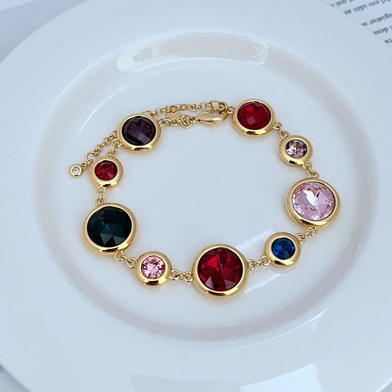 Bracelet on a clean white or soft pastel background, highlighting the raised enamel dots and gold-tone metal. Alt: “Kate Spade On The Dot Bracelet – Colorful Polka Dot Enamel Jewelry.”