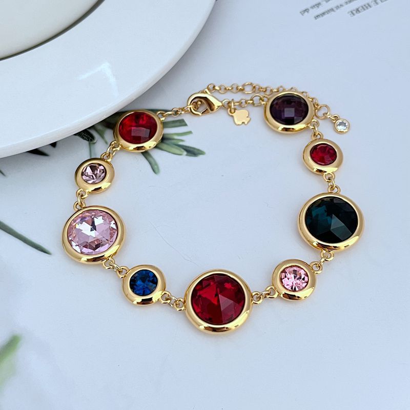 Bracelet on a clean white or soft pastel background, highlighting the raised enamel dots and gold-tone metal. Alt: “Kate Spade On The Dot Bracelet – Colorful Polka Dot Enamel Jewelry.”
