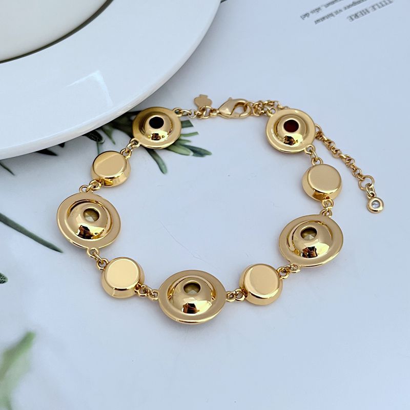  Macro focus on the enamel dots, showing their glossy finish and precise placement. Alt: “Vibrant Enamel Dot Detail – Kate Spade On The Dot Bracelet.”