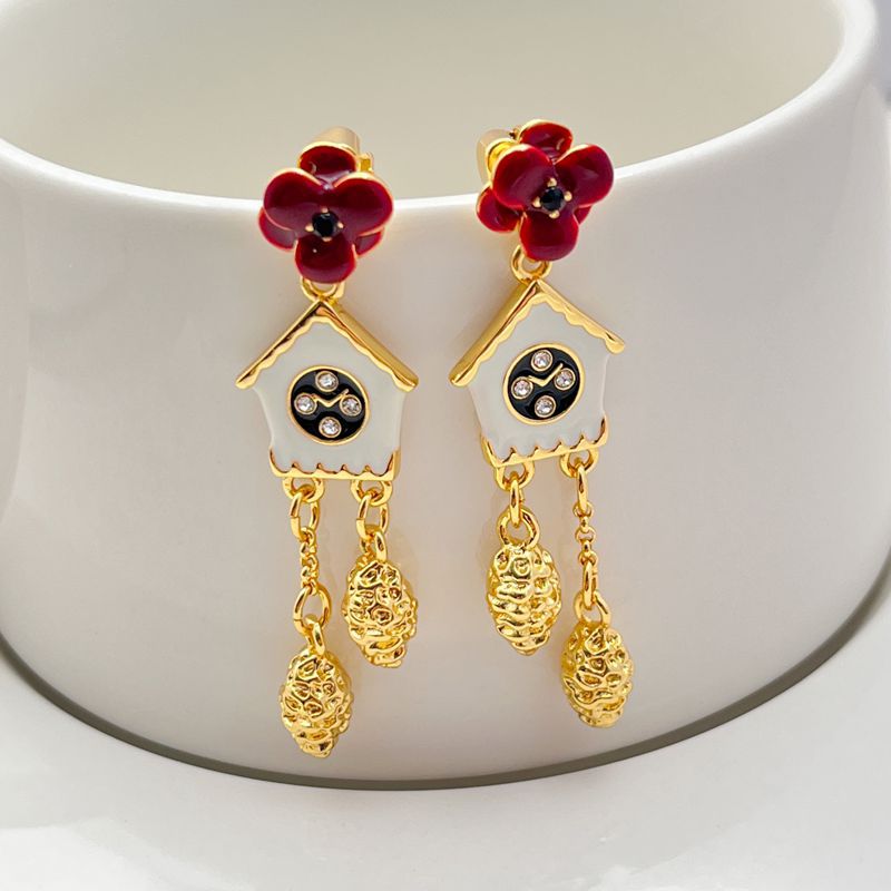 Earrings on a soft cream or French blue background, showcasing the miniature cuckoo clock charms with bird and pendulum details. Alt: “Kate Spade Ooh La La Cuckoo Clock Earrings NEW – Whimsical Enamel Drop Jewelry.”