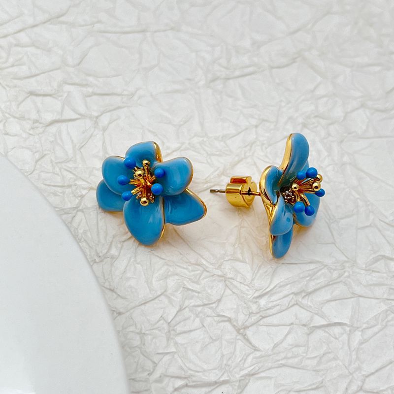  Earrings on a soft cream or dusty rose background, showcasing the pastel enamel petals. Alt: “Kate Spade Pastel Petals Stud Earrings – Floral Enamel Jewelry.”