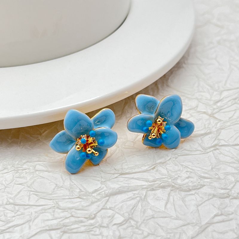  Earrings on a soft cream or dusty rose background, showcasing the pastel enamel petals. Alt: “Kate Spade Pastel Petals Stud Earrings – Floral Enamel Jewelry.”