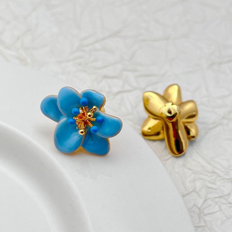  Earrings on a soft cream or dusty rose background, showcasing the pastel enamel petals. Alt: “Kate Spade Pastel Petals Stud Earrings – Floral Enamel Jewelry.”