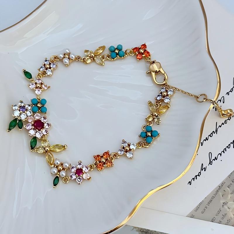 Bracelet displayed on a soft linen or weathered wood background, evoking a rustic, pastoral feel. Alt: “Kate Spade Pastoral Style Floral Bracelet – Enamel Flower Charm Jewelry.”