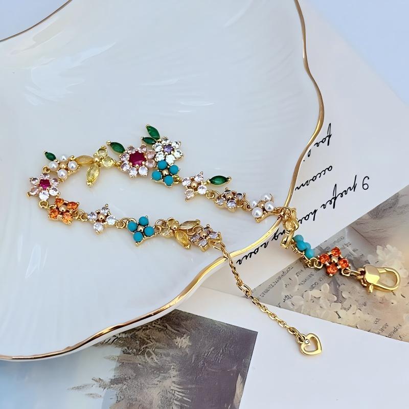 Bracelet displayed on a soft linen or weathered wood background, evoking a rustic, pastoral feel. Alt: “Kate Spade Pastoral Style Floral Bracelet – Enamel Flower Charm Jewelry.”