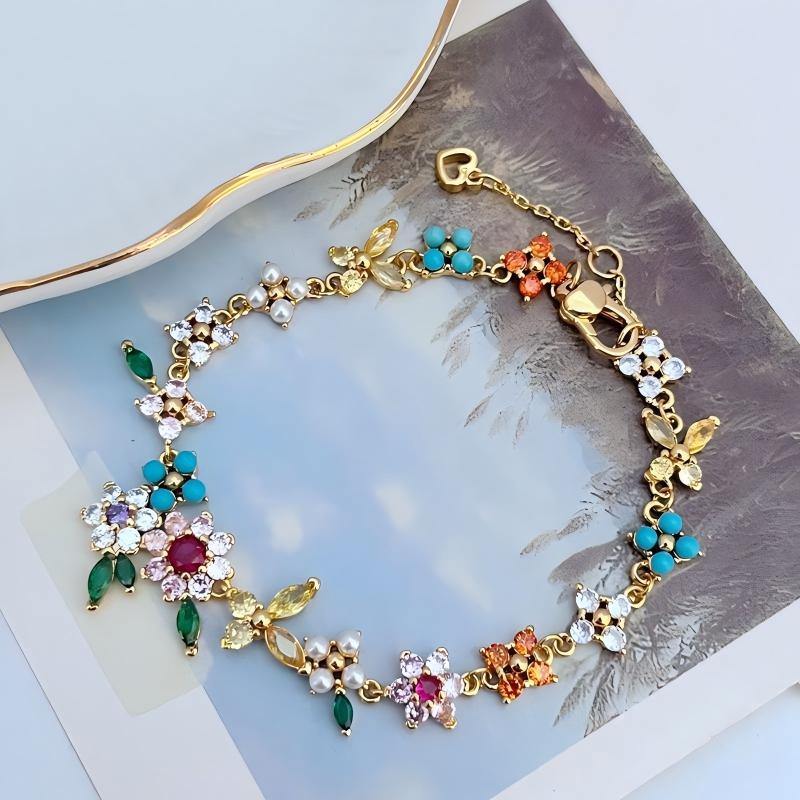 Bracelet displayed on a soft linen or weathered wood background, evoking a rustic, pastoral feel. Alt: “Kate Spade Pastoral Style Floral Bracelet – Enamel Flower Charm Jewelry.”