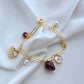  Bracelet displayed on a red gingham or soft cream background, evoking a classic picnic aesthetic. Alt: “Kate Spade Picnic Basket and Strawberry Bracelet – Summer Enamel Charm Jewelry.”