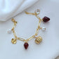  Bracelet displayed on a red gingham or soft cream background, evoking a classic picnic aesthetic. Alt: “Kate Spade Picnic Basket and Strawberry Bracelet – Summer Enamel Charm Jewelry.”