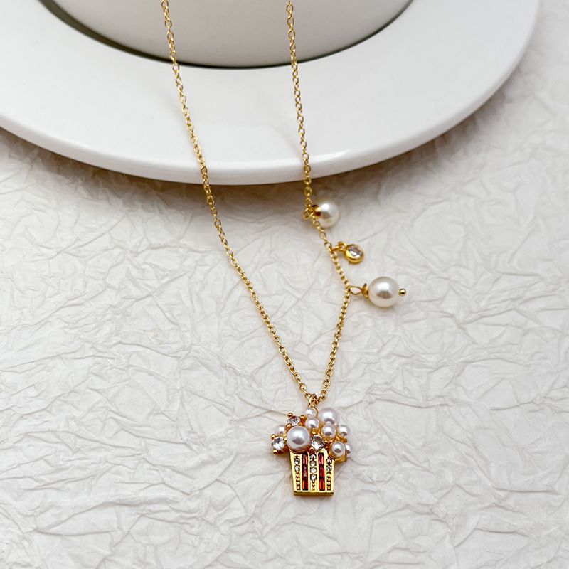 Clean, bright shot of the necklace on a solid, playful background, highlighting the detailed popcorn charm.