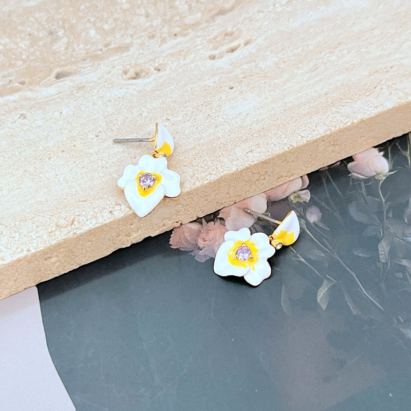  Earrings on a soft lavender or cream background, showcasing the purple and gold pansy blooms with delicate drop findings. Alt: “Kate Spade Precious Pansy Drop Earrings – Enamel Pansy Flower Jewelry.”