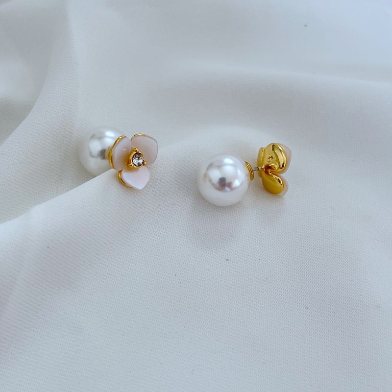  Extreme close-up on the pansy charm, showcasing the intricate petal texture and sculptural detail.