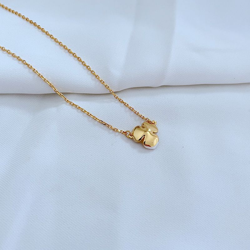  Extreme close-up on the pansy charm, showcasing the intricate petal texture and sculptural detail.