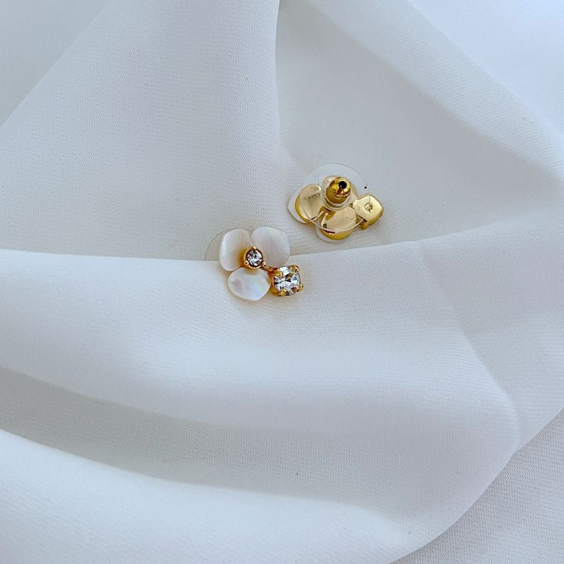  Extreme close-up on the pansy charm, showcasing the intricate petal texture and sculptural detail.