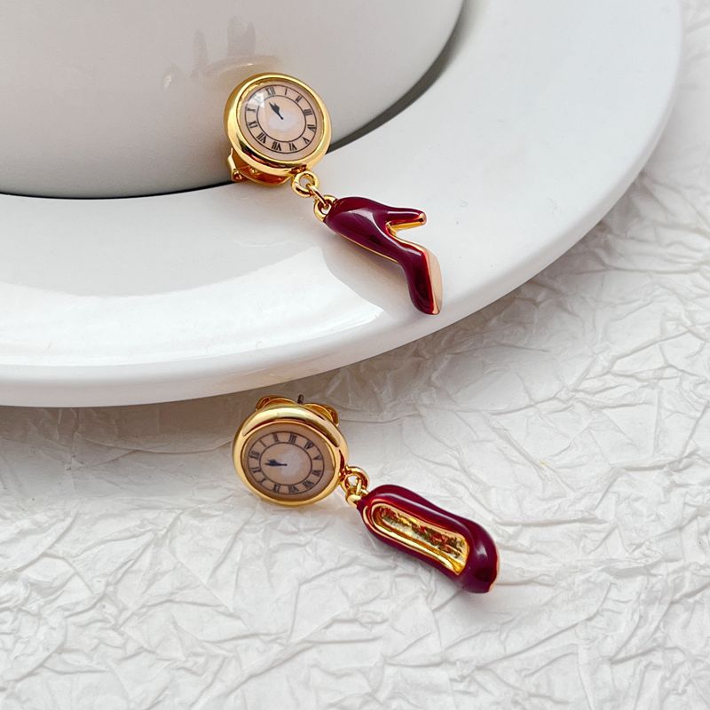  Earrings displayed side by side on a soft blush or cream background, showcasing the red heel and antique clock charms. Alt: “Kate Spade Red Heels and Clock Earrings – Whimsical Mismatched Jewelry Gift for Her.”

