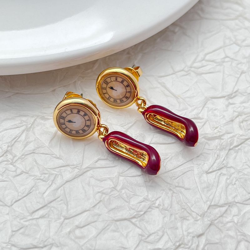  Earrings displayed side by side on a soft blush or cream background, showcasing the red heel and antique clock charms. Alt: “Kate Spade Red Heels and Clock Earrings – Whimsical Mismatched Jewelry Gift for Her.”

