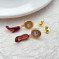  Earrings displayed side by side on a soft blush or cream background, showcasing the red heel and antique clock charms. Alt: “Kate Spade Red Heels and Clock Earrings – Whimsical Mismatched Jewelry Gift for Her.”

