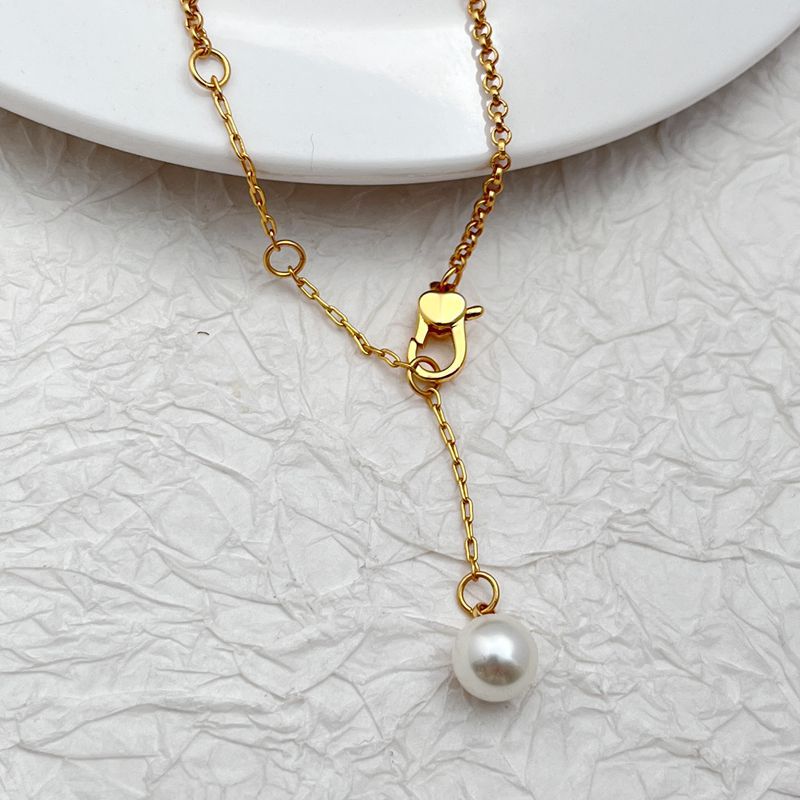 Necklace laid flat on a sandy-beige or light blue background, emphasizing the starfish pendant's shape and detail. Alt: “Kate Spade Sea Star Necklace – Delicate Starfish Pendant Jewelry.”