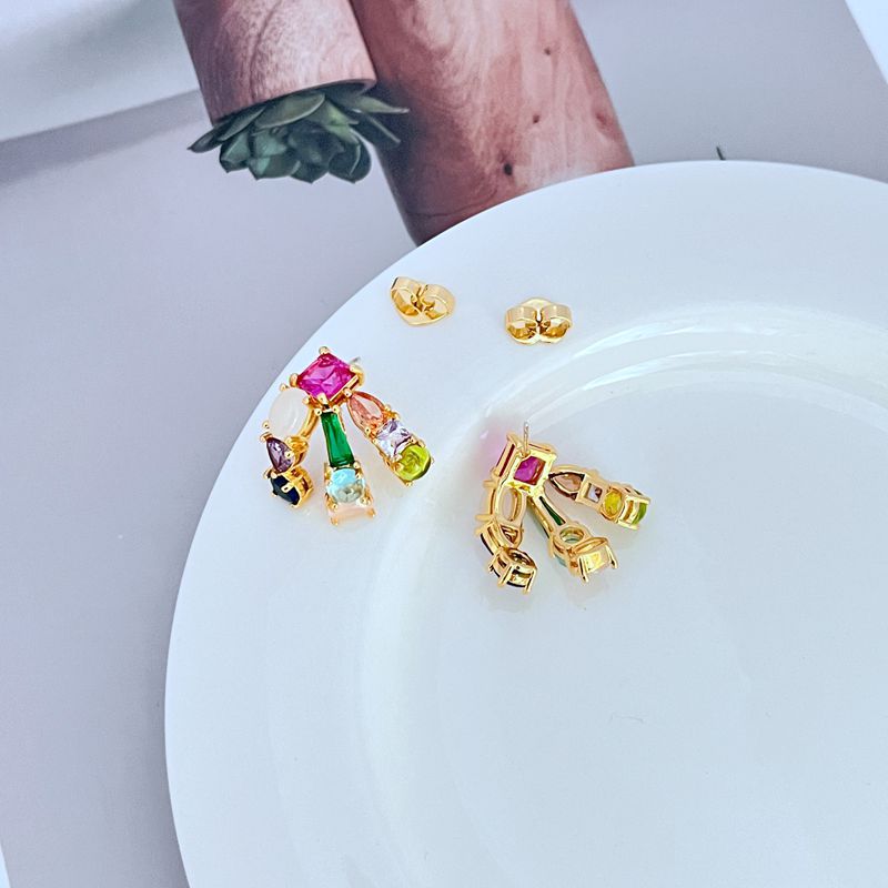  Macro focus on the hoop's crystal setting, highlighting the brilliance and precision of the pavé. Alt: “Pavé Crystal Huggie Detail – Kate Spade Showtime Hoops.”