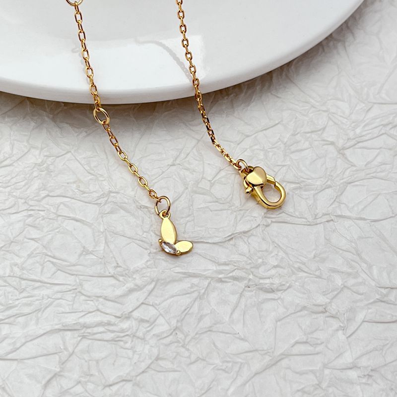 Necklace displayed on a clean, light background, showcasing the layered chains and sparkling butterfly pendant. Alt: “Kate Spade Social Butterfly Double Strand Necklace – Crystal Butterfly Layered Jewelry.”