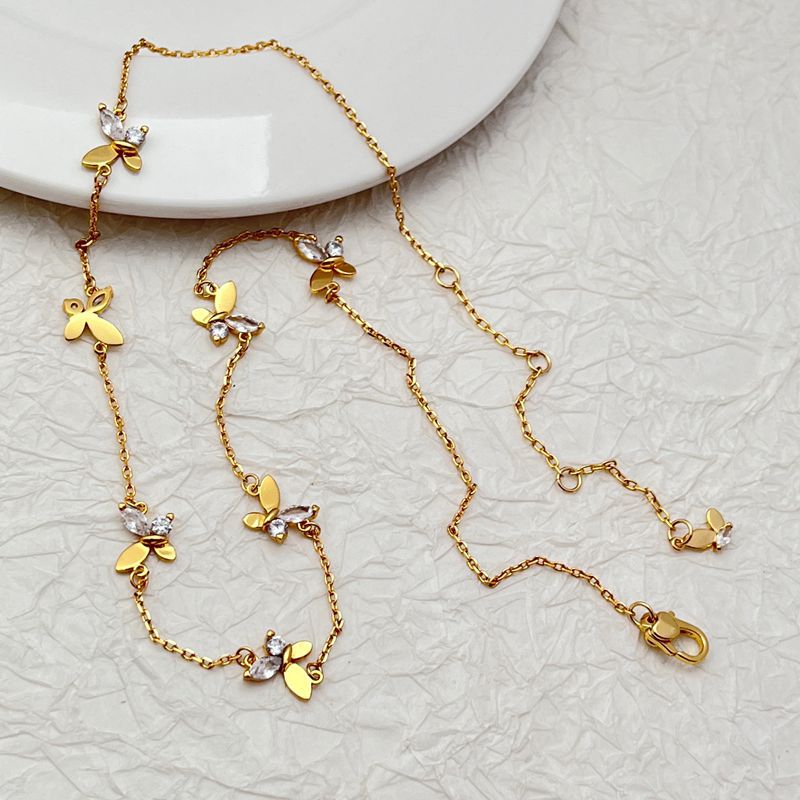 Necklace displayed on a clean, light background, showcasing the layered chains and sparkling butterfly pendant. Alt: “Kate Spade Social Butterfly Double Strand Necklace – Crystal Butterfly Layered Jewelry.”