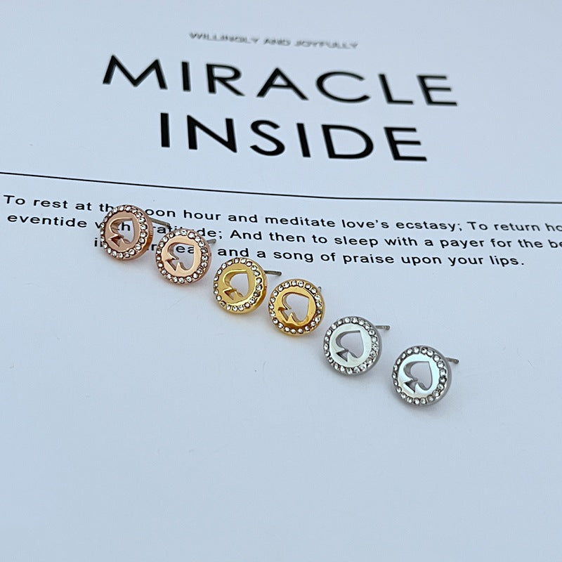  Earrings on a clean white or soft grey background, showcasing the crystal-pavé spade shape. Alt: “Kate Spade Spot The Spade Gold Tone Crystal Stud Earrings – Pavé Spade Jewelry.”